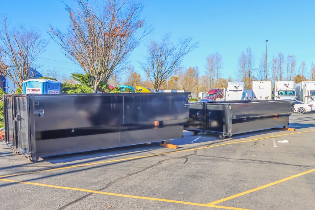 Professional dumpster rental service with roll-off container on residential driveway in Newington Forest